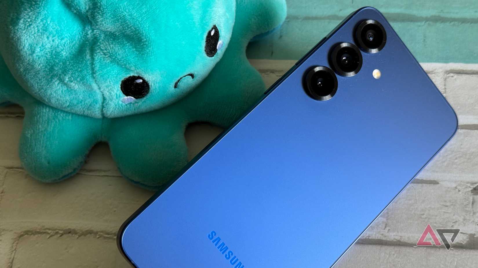 Samsung Galaxy S25+ sitting next to a plush with a sad face