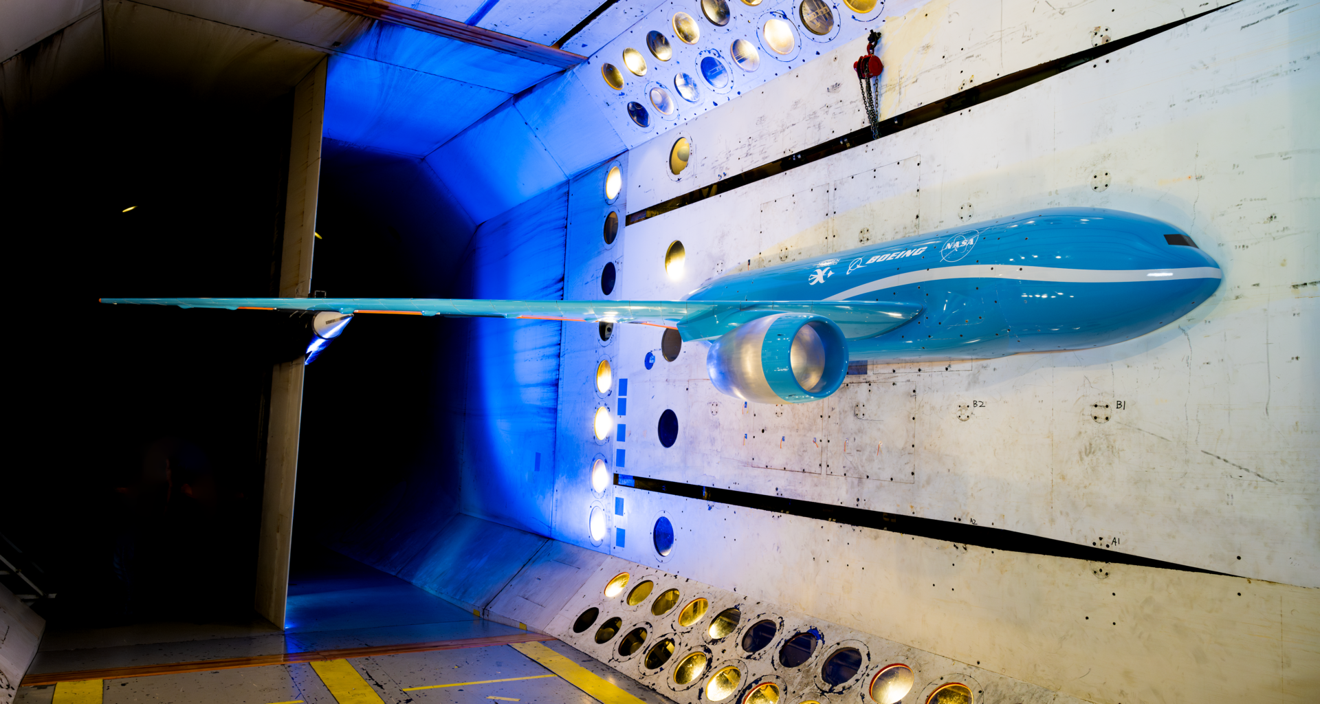 A scale model of possible future commercial jet airplane sits inside a NASA wind tunnel where the aircraft wing was tested.