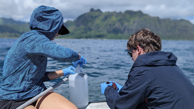 two people sampling water