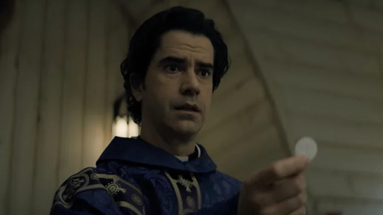 Paul Hill (Hamish Linklater) solemnly offers a communion wafer in Midnight Mass