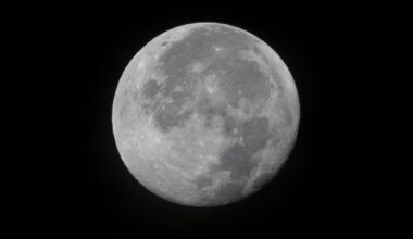 A full moon against an inky black space backdrop