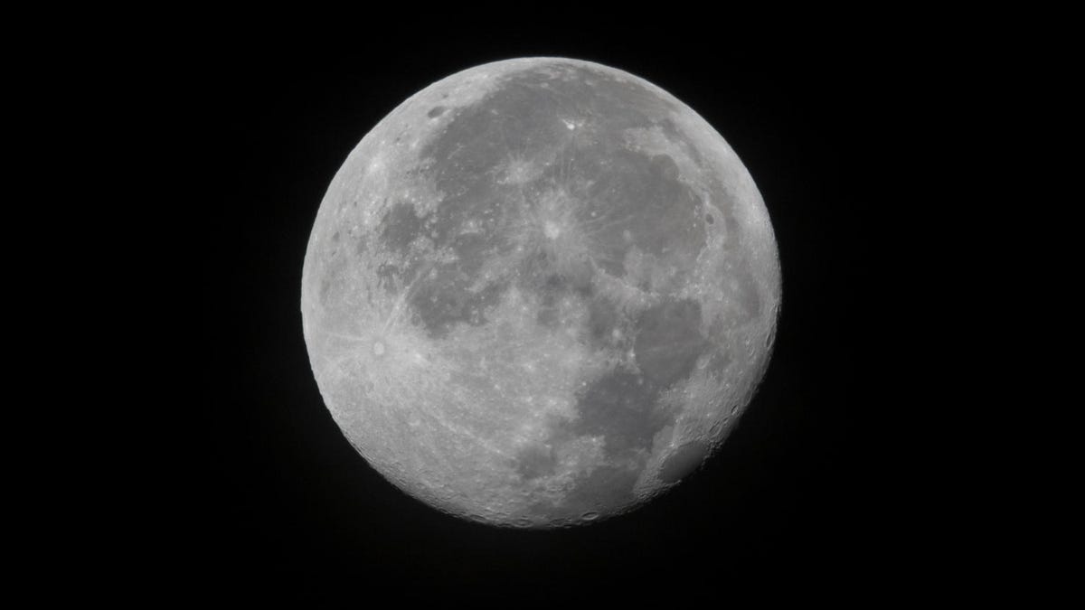 A full moon against an inky black space backdrop