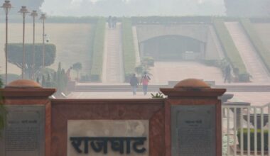 People visit the Rajghat as a layer of smog engulfs the city amid deteriorated air quality.