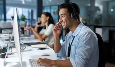 A man in front of a desktop.