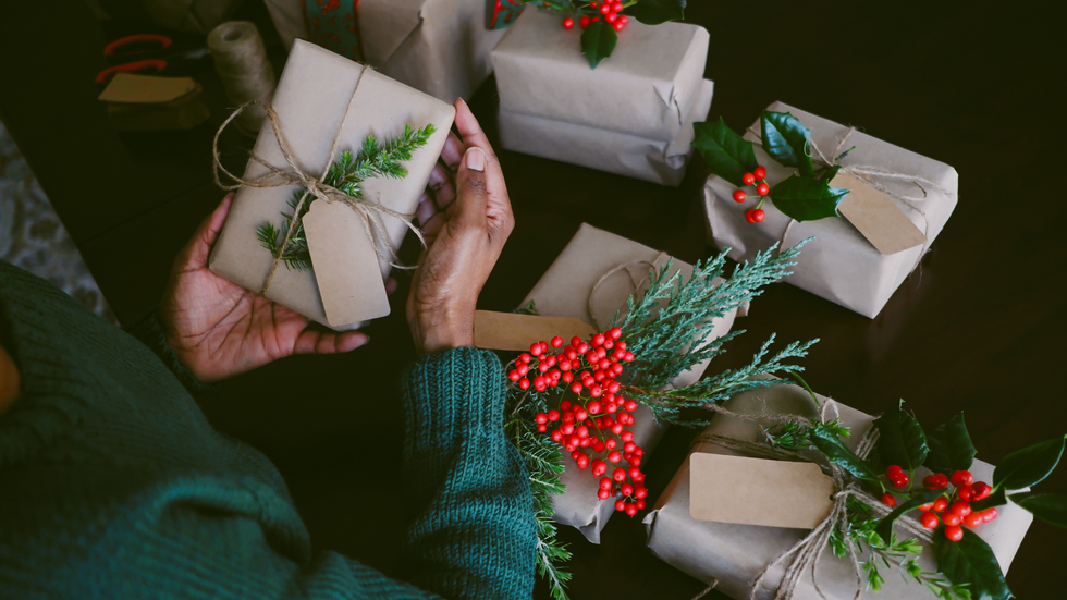 Person wrapping Christmas presents