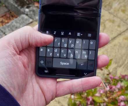 A person using the QWERTY Mini keyboard