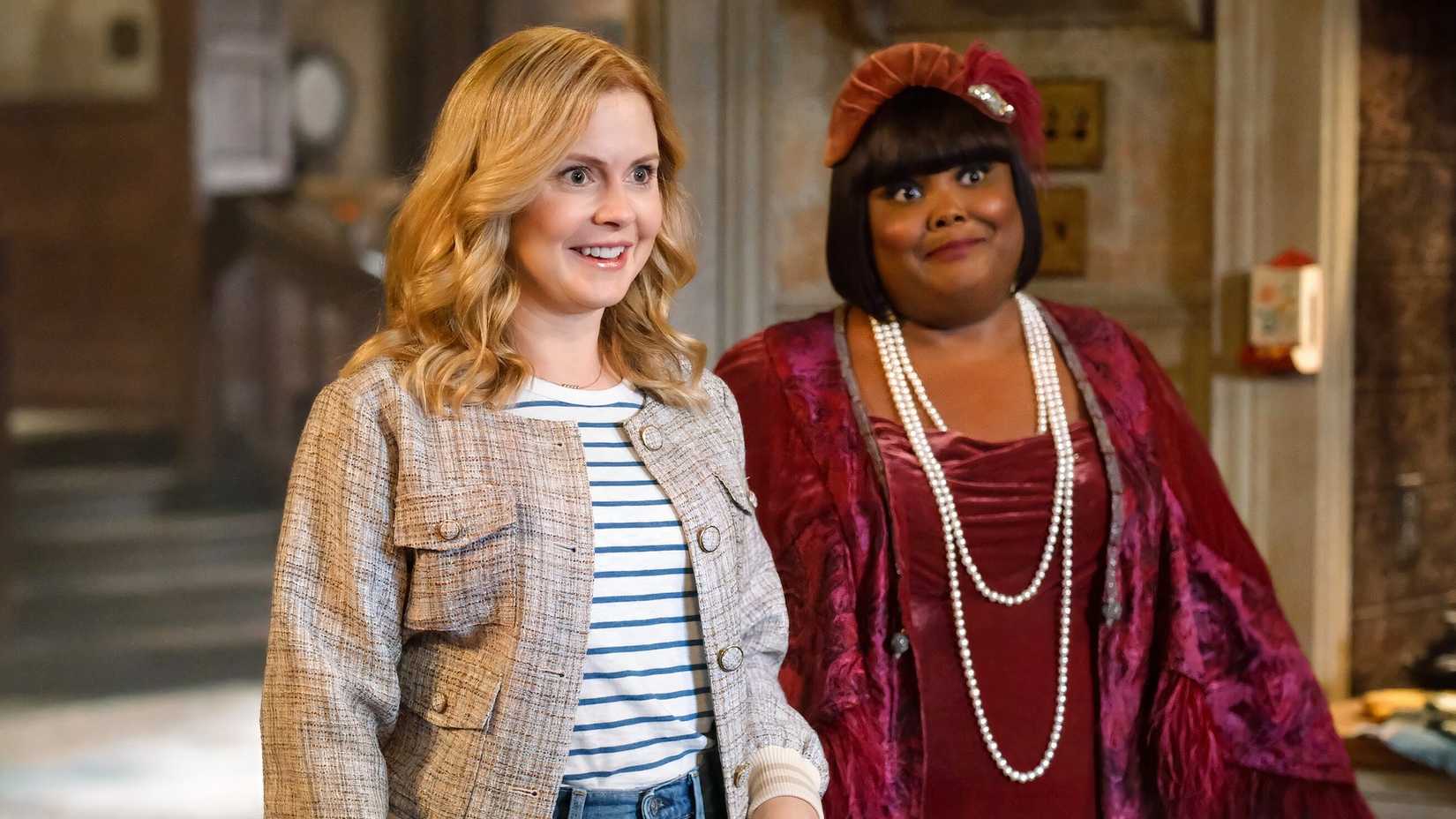 Rose McIver's Sam and Danielle Pinnock's Alberta stand in a hallway in Ghosts