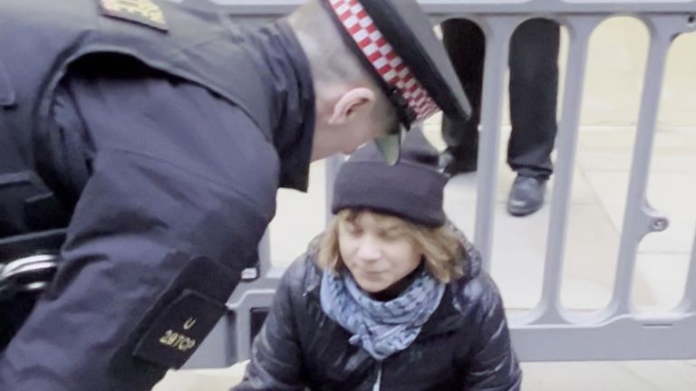 The activist being spoken to by officers from the City of London Police.
Pic: Prisoners for Palestine/PA