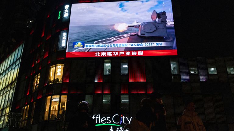 A big screen during shows news on China's military drills around Taiwan, in Beijing. Pic: Reuters