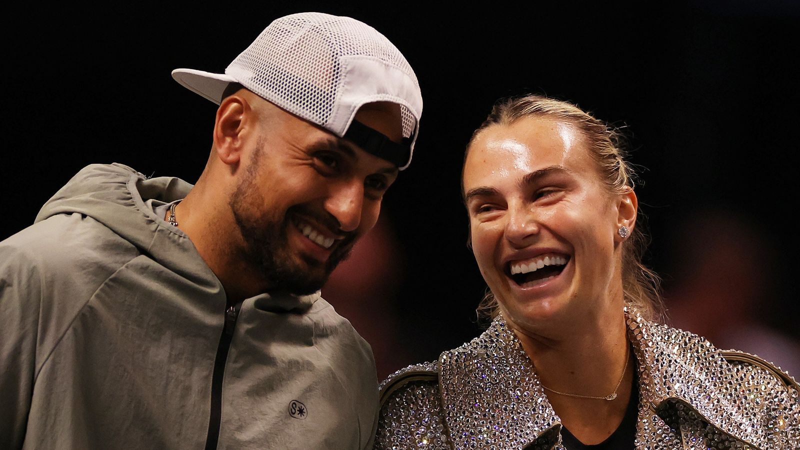 Aryna Sabalenka and Nick Kyrgios laugh ahead of their Battle of the Sexes tennis match in Dubai, United Arab Emirates, Sunday Dec. 28, 2025. (Amr Alfiky/Pool Photo via AP)