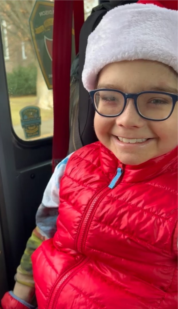 Henry Neligon smiles riding in the fire truck in the Santa parade in Madison on Saturday, Dec. 6. (Contributed photo)