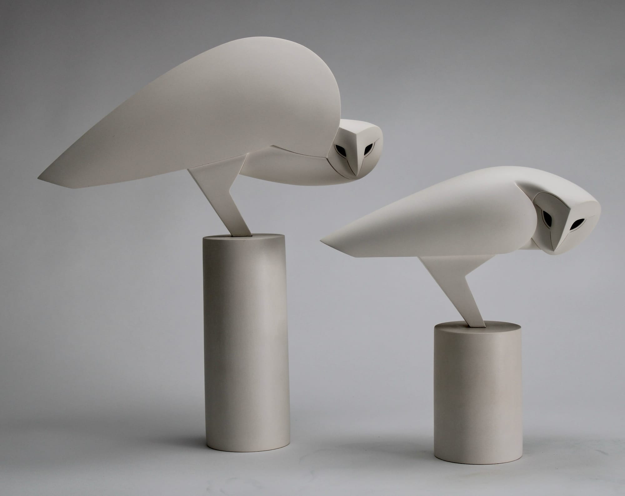 two stone owl sculptures by Anthony Theakston