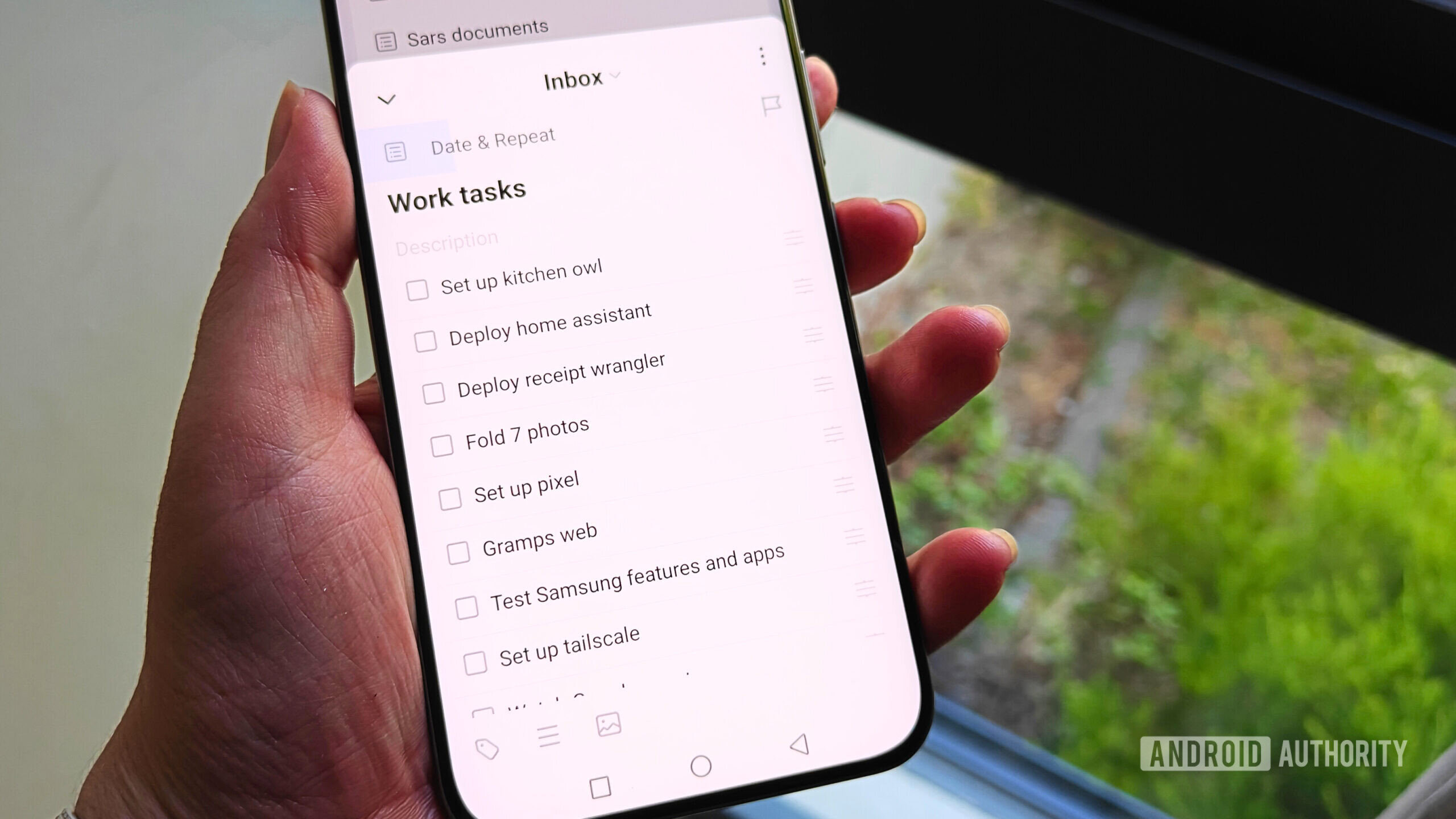 ticktick tasks on a smartphone held in a hand ticktick tasks on a smartphone held in a hand