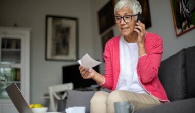 Person holding check and talking on phone.