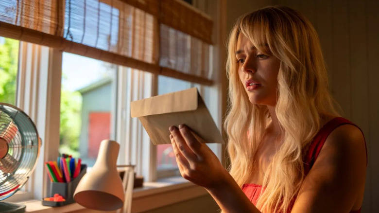 Emily Alyn Lind as Cady, reading a letter in We Were Liars