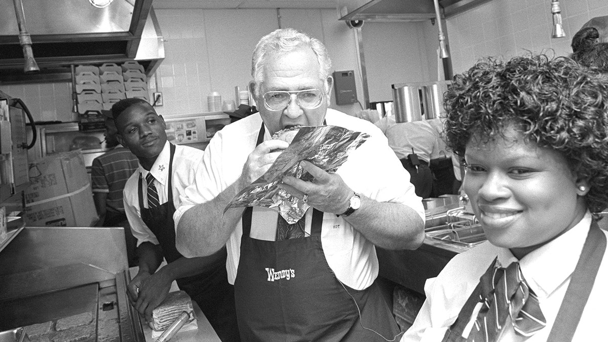Dave Thomas eating burger