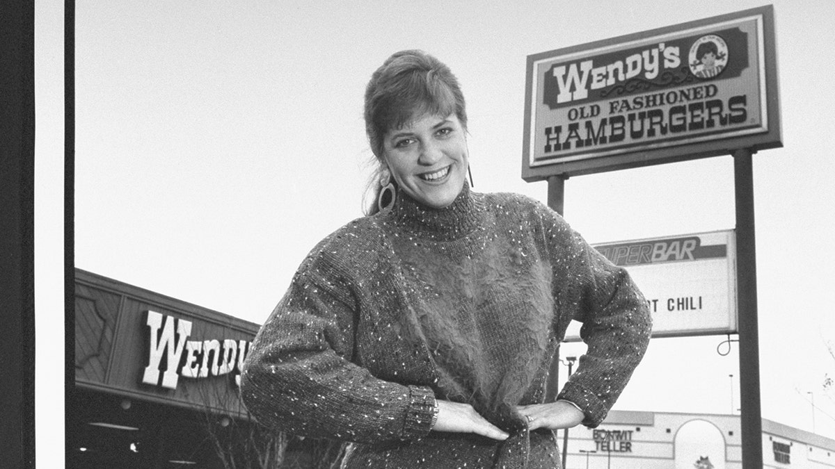 Wendy Thomas in front of sign