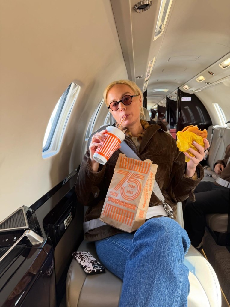 Brie Larson chows down on some fast food from Whataburger before takeoff.