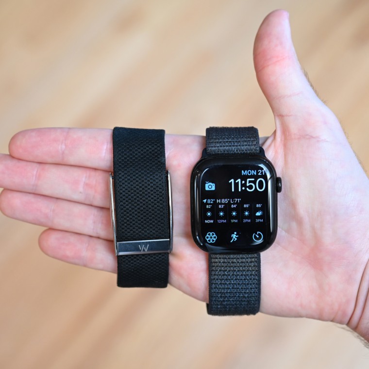 A close-up of the Whoop MG and Apple Watch Series 10 in the hand of the writer.