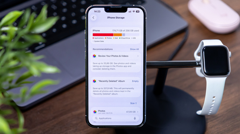 iPhone on charging dock with storage page on screen