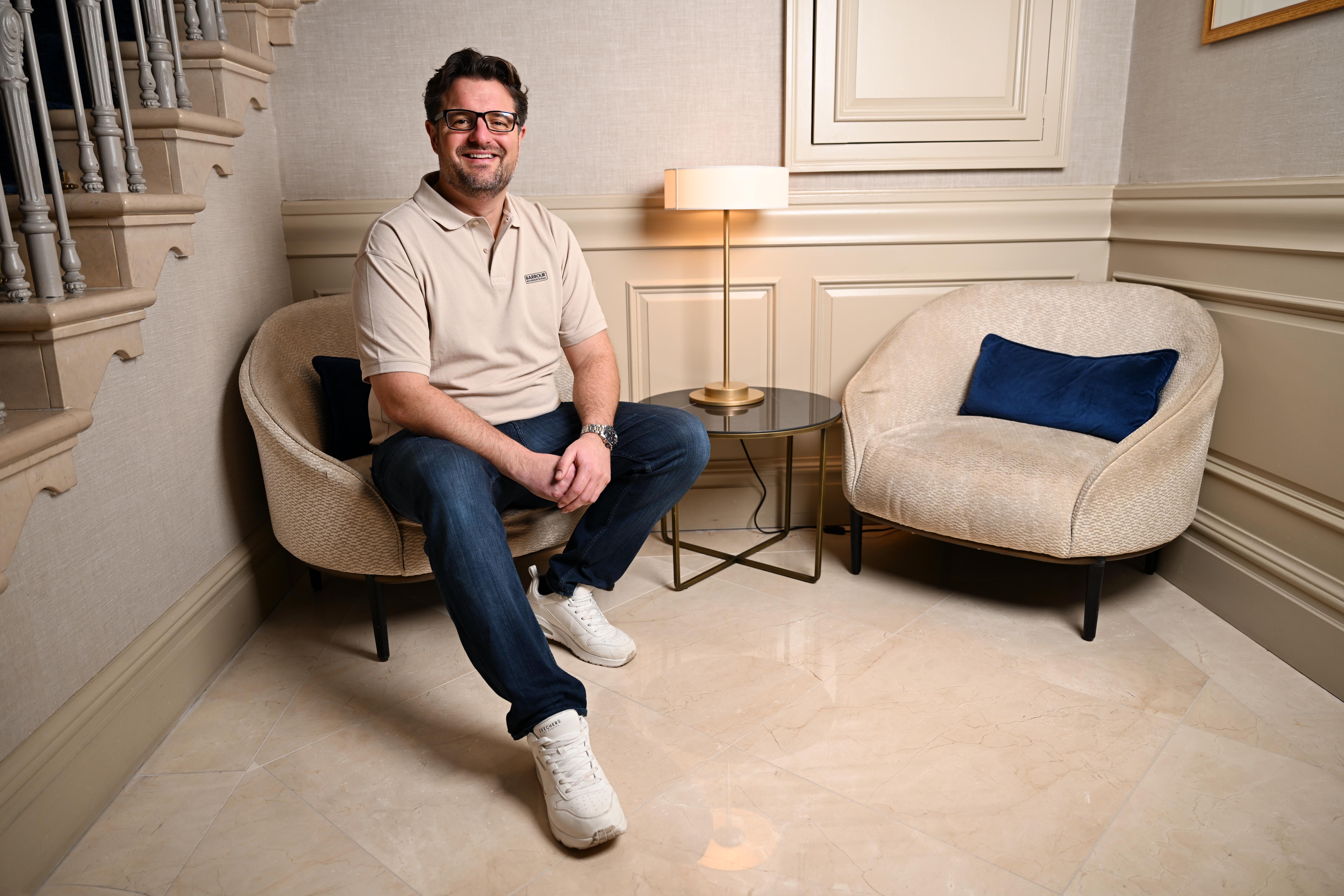 Eoin McGee, financial planner and author, sitting in a chair.