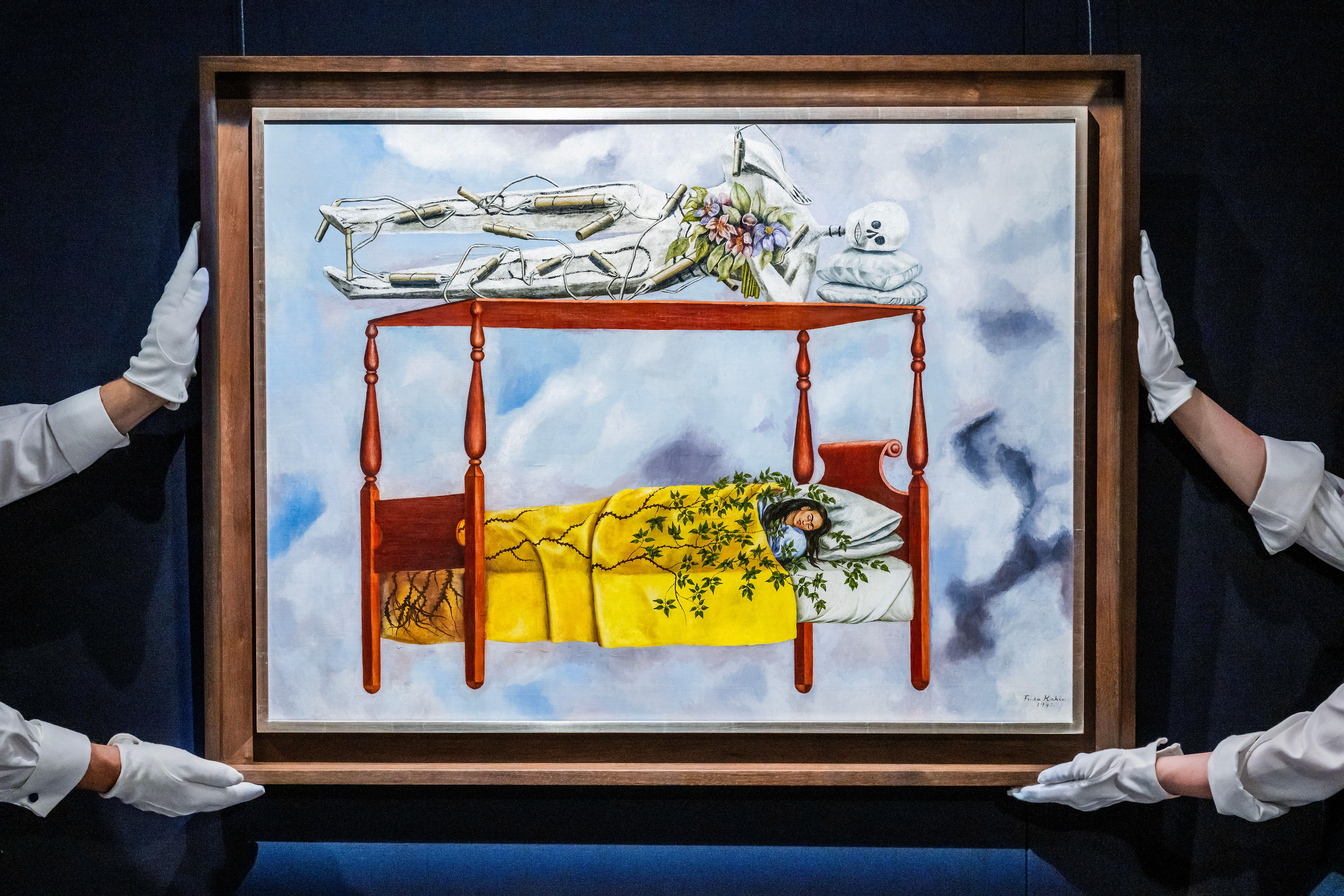 Frida Kahlo's painting "El sueño (La cama)" (The Dream (The Bed)), shows a woman sleeping in a bed covered in green foliage, while an empty skeleton-like structure lies on a canopy above her.