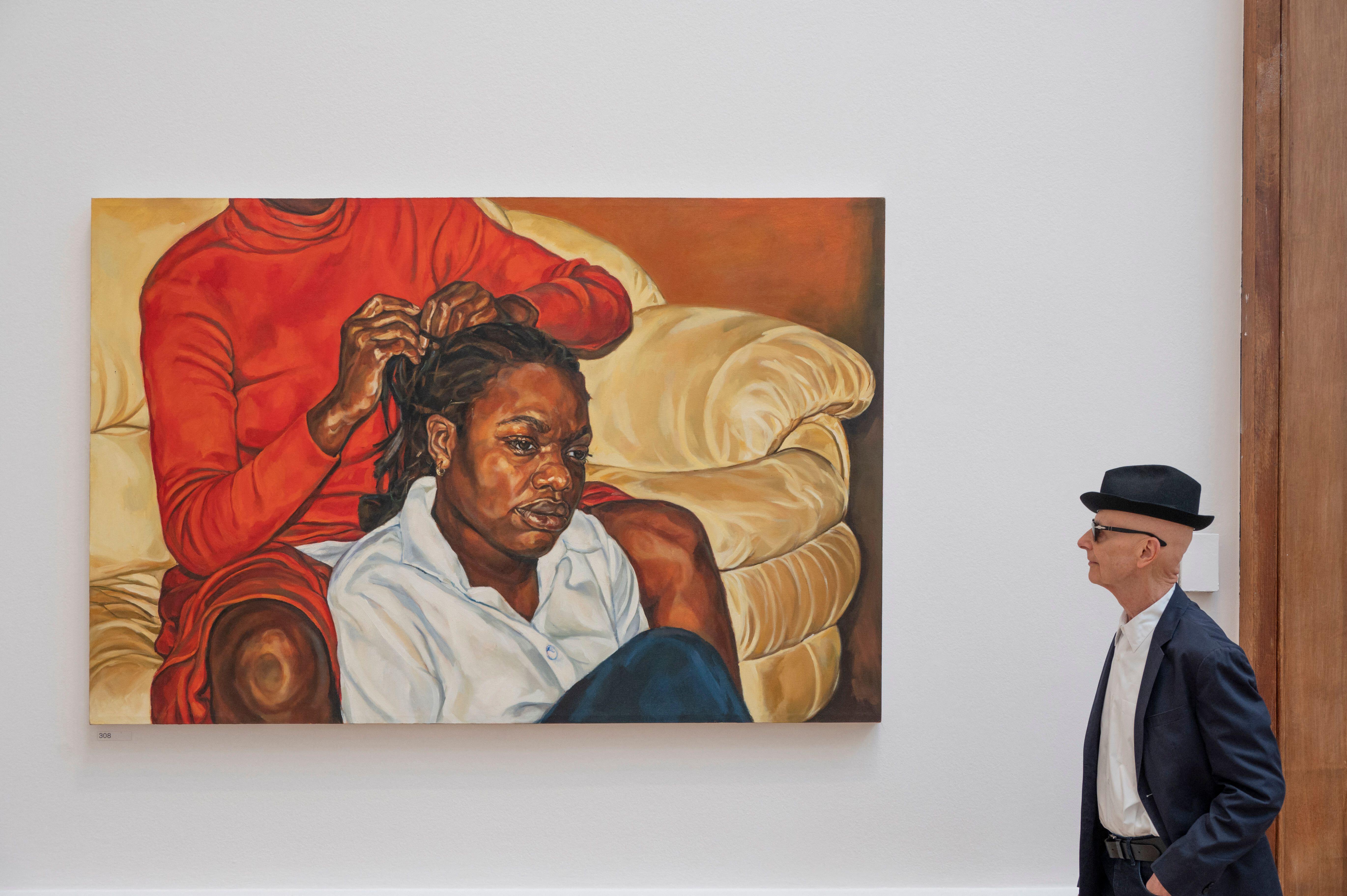 David Remfry, RA, viewing "The Sitter" by Barbara Walker, RA elect, at the Royal Academy Summer Exhibition.