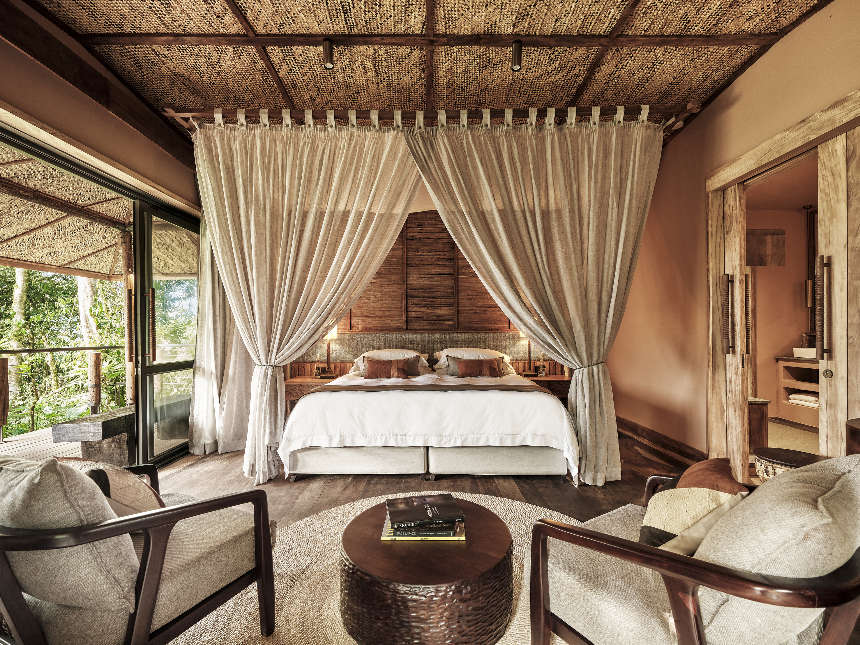 Bedroom at Gorilla Forest Lodge, Uganda, with a view of the forest.