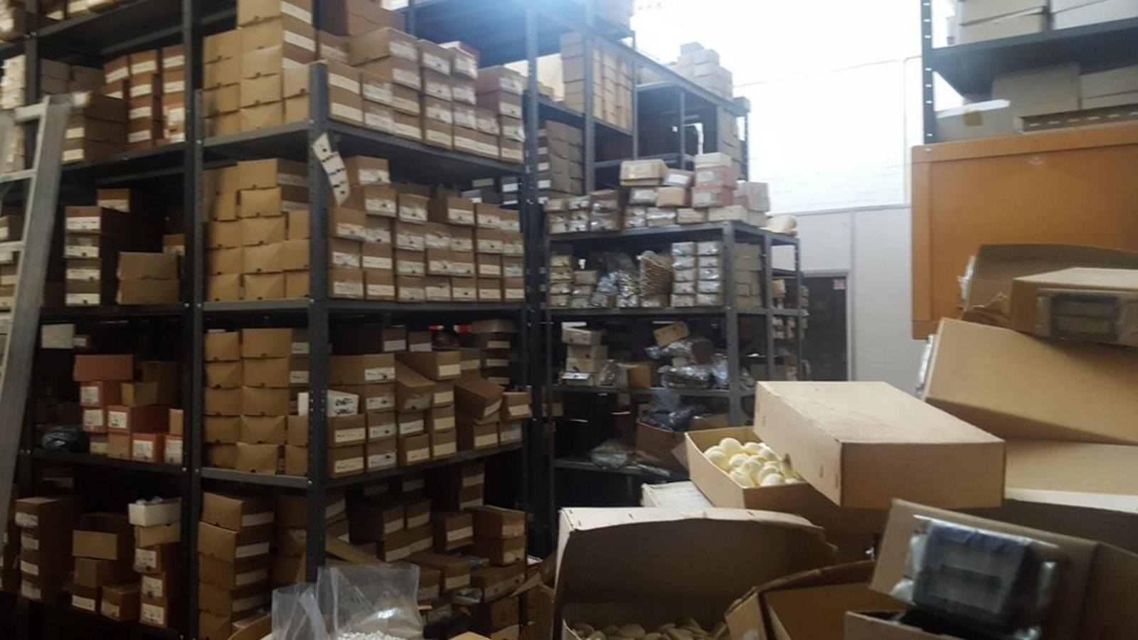 Interior of A Brown & Co Buttons, a shop in Croydon, South London, filled with shelves of boxes.