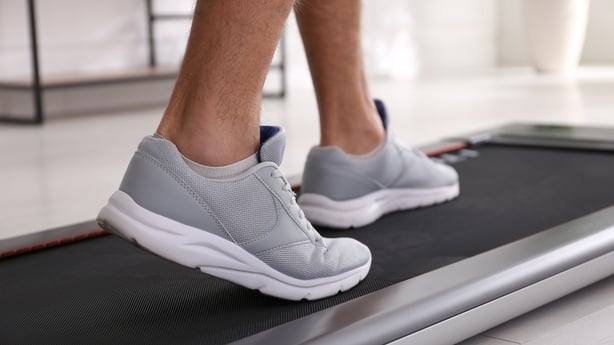 Man training on walking treadmill at home