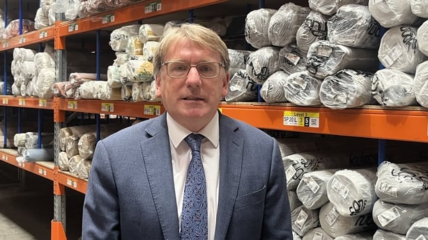 Pictured is Oxfam CEO in Jim Clarken inside the Kukoon rug store