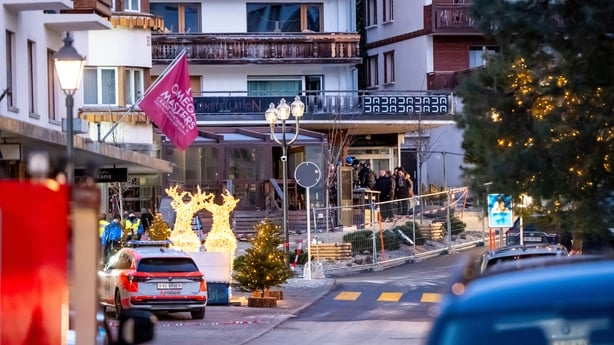 Rescuers and people are seen at the site of an explosion that ripped through a bar in Crans-Montana