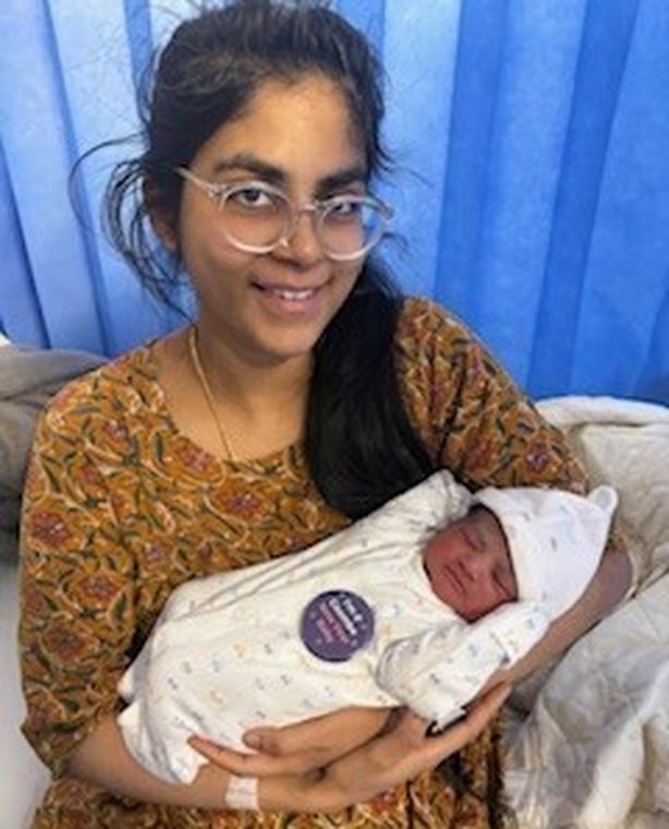 a woman holds a newborn baby 