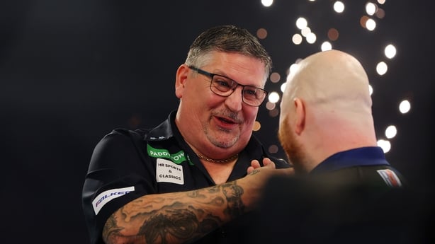 LONDON, ENGLAND - JANUARY 01: Gary Anderson of Scotland embraces Justin Hood of England following his victory in the Quarter-final match between Justin Hood and Gary Anderson on day eighteen of the 2025/26 Paddy Power World Darts Championship at Alexandra Palace on January 01, 2026 in London, Englan