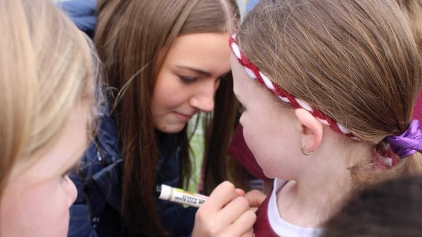 Anna Jordan signs a child's jersey.