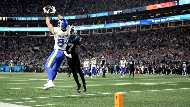CHARLOTTE, NORTH CAROLINA - JANUARY 10: Colby Parkinson #84 of the Los Angeles Rams catches a 19 yard touchdown pass against Tre'von Moehrig #7 of the Carolina Panthers during the fourth quarter in the NFC Wild Card Playoff game at Bank of America Stadium on January 10, 2026 in Charlotte, North Caro