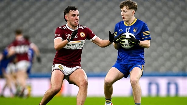 Ballymacelligott's Niall Collins in possession against Seán Bogue of Clogher Éire Óg