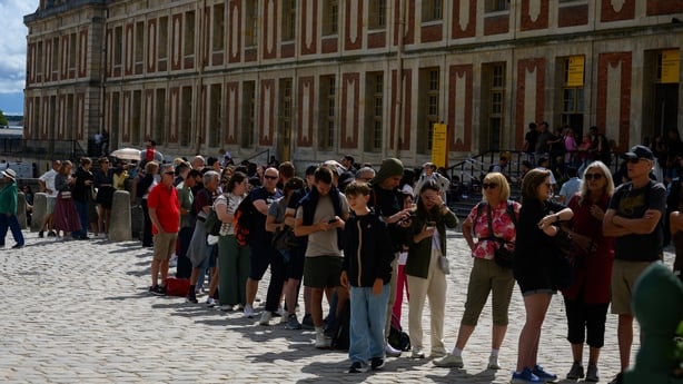People wait in line to enter the palace of Versailles 