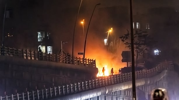 a burning building during a protest in Tehran