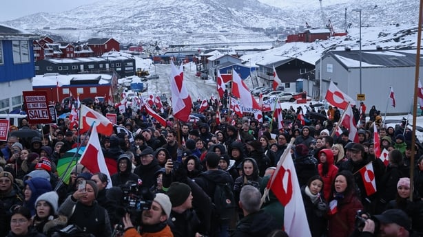NUUK, GREENLAND - JANUARY 17: People bear Greenlandic flags as they march to protest against U.S. President Donald Trump and his announced intent to acquire Greenland on January 17, 2026 in Nuuk, Greenland. Greenlandic, Danish and other European leaders are hoping they can still avert an interventio