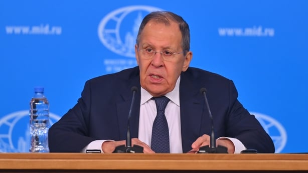 Russian Foreign Minister Sergey Lavrov sits at a desk during the annual press conference at the Russian Foreign Ministry Conference Hall.