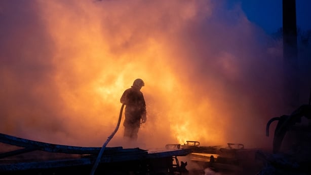A firefighter works to extinguish a fire