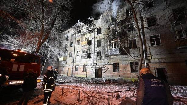 Ukrainian rescuers work at the site of a damaged residential building following an air attack in Kharkiv