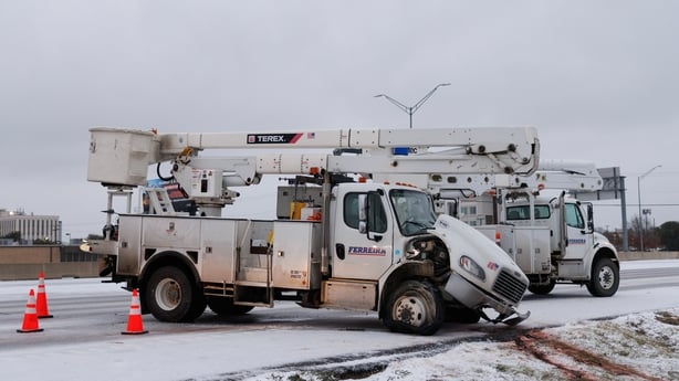 A truck with a damaged bonnet after it slid off a road covered in ice and snow