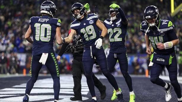 SEATTLE, WASHINGTON - JANUARY 25: Jake Bobo #19 celebrates with Cooper Kupp #10 of the Seattle Seahawks after scoring a touchdown during the third quarter of the NFC Championship NFL football game against the Los Angeles Rams, at Lumen Field on January 25, 2026 in Seattle, Washington. (Photo by Kevi