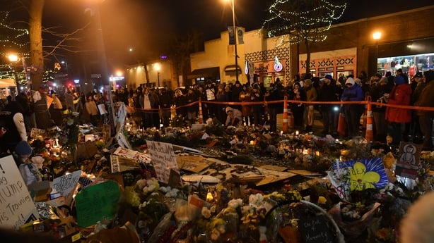 People mourn at a makeshift memorial