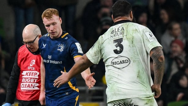 10 January 2026; Ciarán Frawley of Leinster is consoled by Uini Atonio of La Rochelle as he leaves the pitch to receive medical attention with team doctor Frank O'Leary during the Investec Champions Cup match between Leinster and La Rochelle at the Aviva Stadium in Dublin. Photo by Brendan Moran/Spo