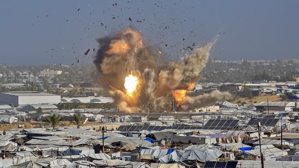 Smoke and fire rises from the Gath shelter, housing displaced Palestinians, after an Israeli air strike