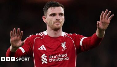 Andy Robertson holds up his hands in a calming gesture during a Liverpool game