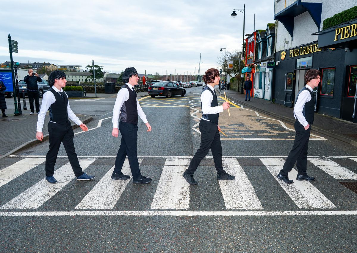 The band recreating the iconic cover of Abbey Road